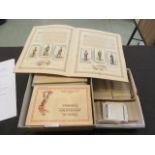 A carton containing trade cards, cigarette cards,