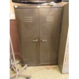 An industrial metal two door cabinet