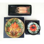 A Moorcroft Poppy pattern pin dish together with a Moorcroft Cluny pattern tray and a Moorcroft