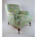 An early 20th century Howard and Sons arm chair with walnut legs,