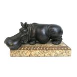 A stylized bronze model of a hippo on a marble and gilt wood base, l.