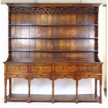 A reproduction 18th century style oak dresser, the plate rack over the base with four drawers,