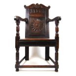 A 17th century oak panel back wainscot chair,