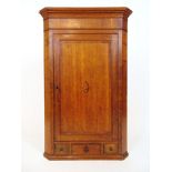 An 18th century oak wall hanging corner cupboard,