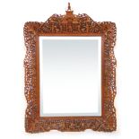 An early 20th century Chinese carved frame bevel glass mirror h.75 cm, w.