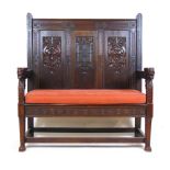 An early 20th century carved oak settle,