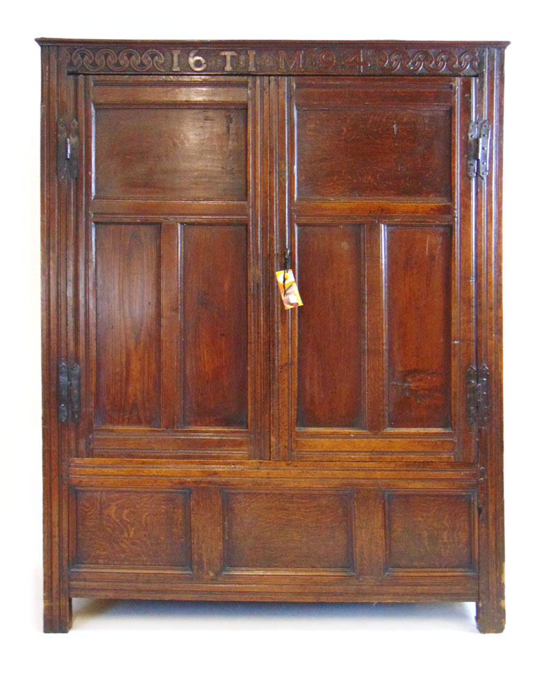 A late 17th century oak paneled cupboard,