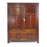 A late 17th century oak paneled cupboard,