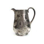 A Victorian silver jug, the body with engraved scrolling decoration and vacant cartouches.