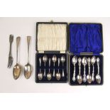 An assortment of silver flatware to include two cased sets of teaspoons,