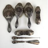 An Edwardian silver Art Nouveau design five piece dressing table set with matching shoe horn and