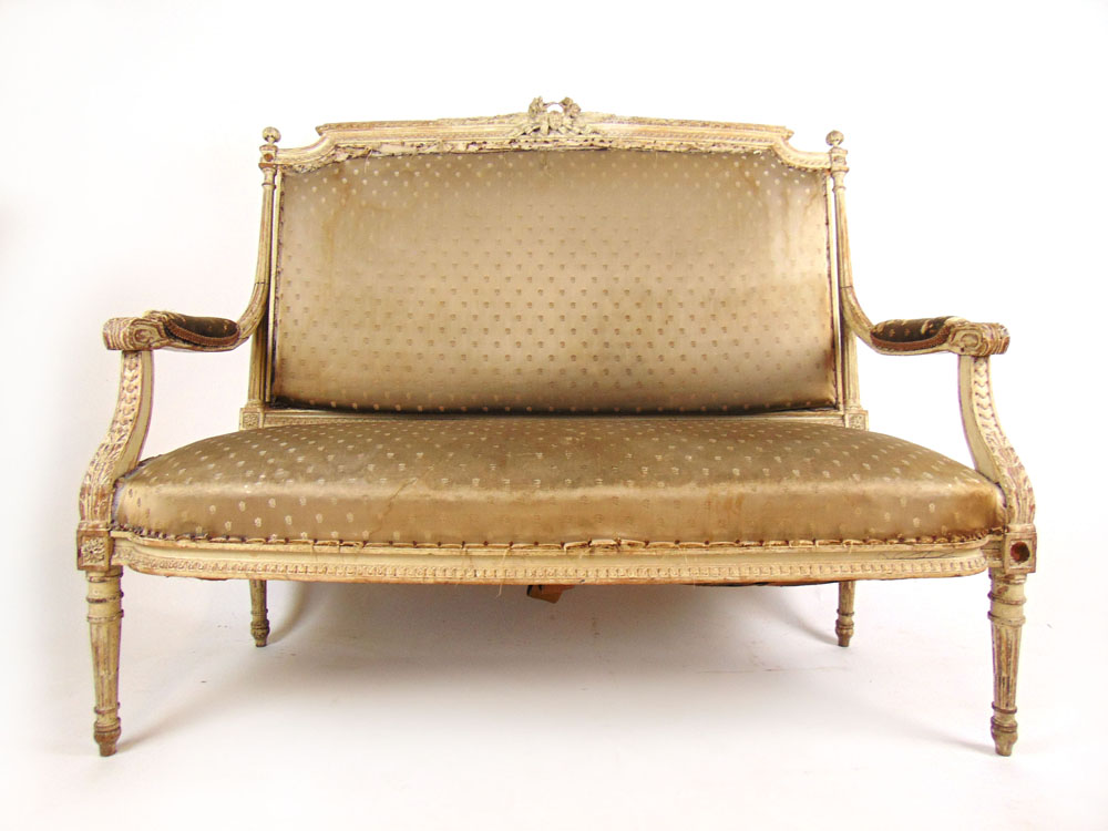 A 19th century distressed cream two seat settee, the carved and moulded frame on turned legs, h.