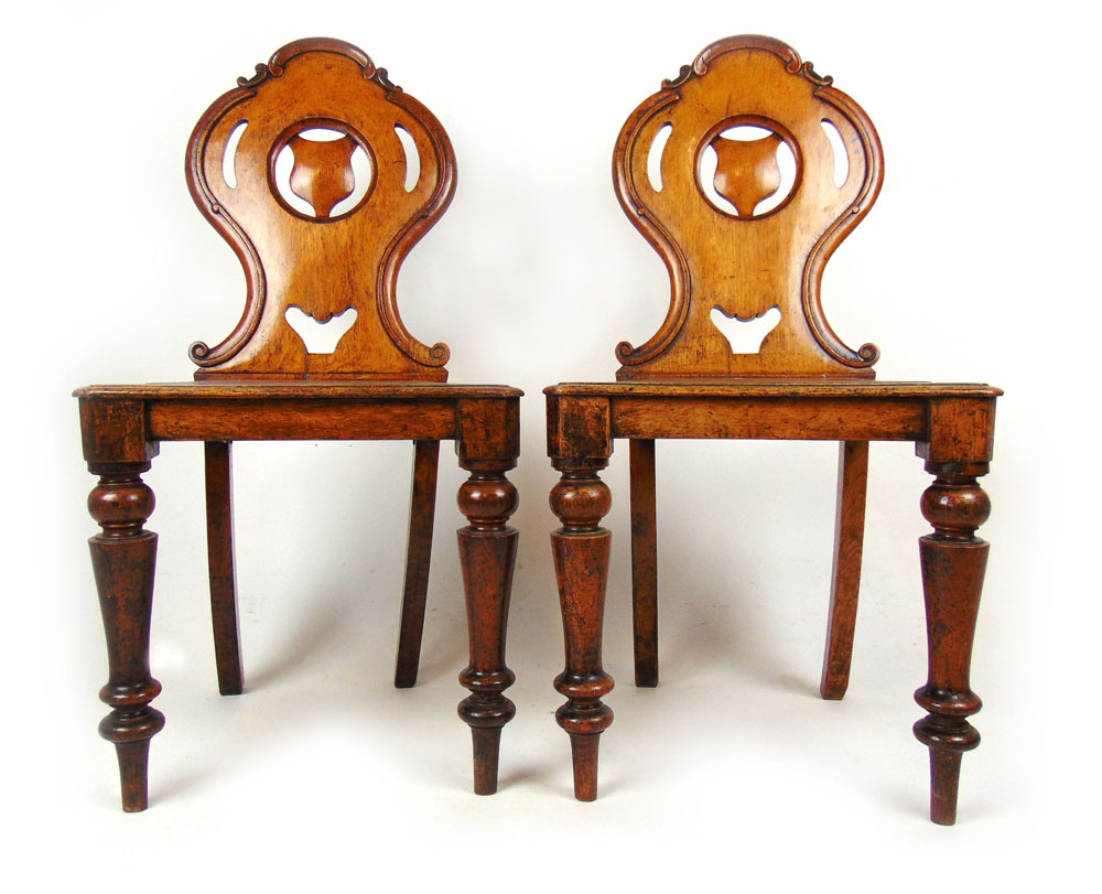 A pair of 19th century oak shield back hall chairs with solid seat on turned legs, h. 86 cm, w.