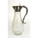 An Edwardian silver mounted and cut glass claret jug of small proportions.