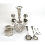 An assortment of silver items to include a pair of salt and pepper pots, vase, bon bon dish,