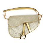 A ladies Christian Dior saddle bag with cream and gold detailing