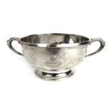 A George V silver twin handled bowl having engraved armorial decoration.