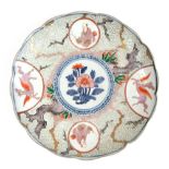 An 18th century Chinese porcelain plate painted with winged horses and floral motifs within a