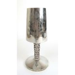 An Elizabeth II silver goblet of Modernist design, the planished bowl supported by an openwork stem.