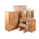 An Arts and Crafts limed oak bedroom suite comprising of ladies wardrobe, gentleman's wardrobe,