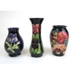 A collection of three small Moorcroft vases to include the Anemone and Violet patterns, max h. 12.