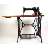 A Singer leather sewing machine model No. 16K 115, on treadle base with later top, h.