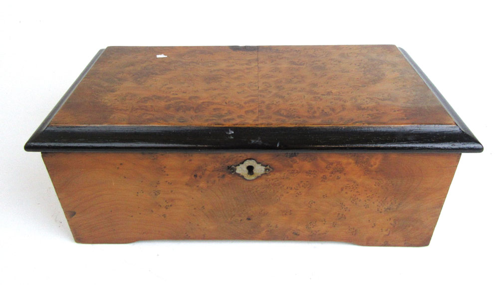 A 19th century burr walnut cased cylinder music box bearing Paillard Vaucher Fils label under lid,