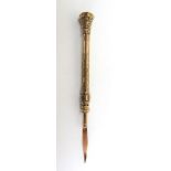 A 19th century yellow metal propelling toothpick with engraved decoration and yellow stone set top,