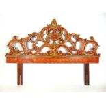 A 20th century Italian parcel gilt and red painted carved and pierced headboard, h. 132 cm, l.