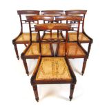 A set of six Regency mahogany dining chairs, with caned seats on turned and reeded legs, h.