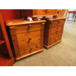 A pair of pine three drawer bedside chests