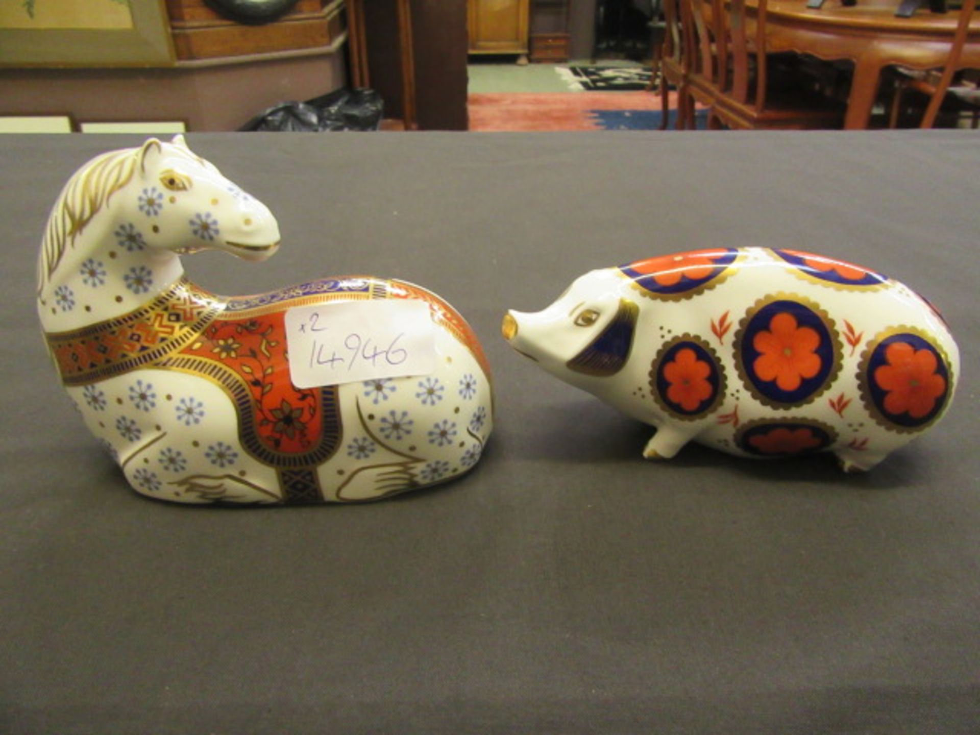 Two Royal Crown Derby paperweights, one of lying horse,