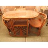 A bamboo and wicker garden table with two chairs under