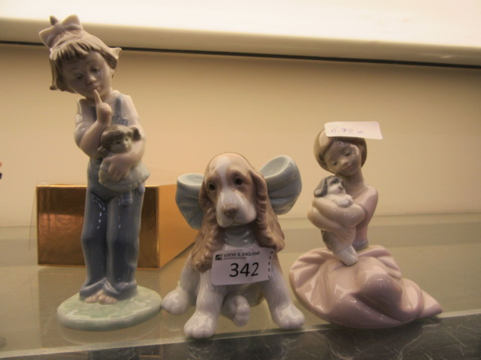 Three Nao figurines, one of a dog,