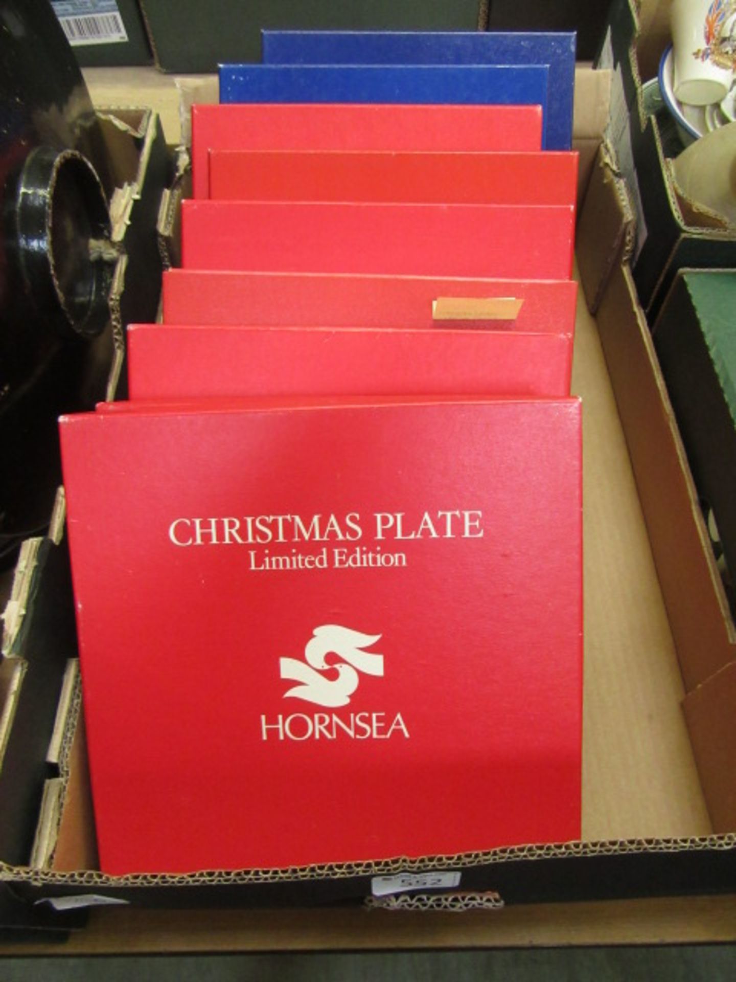 A tray containing boxed Hornsea limited edition Christmas plates