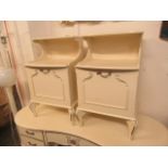 A pair of cream and parcel gilt bedside cabinets