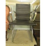 A modern chrome and black leather office chair