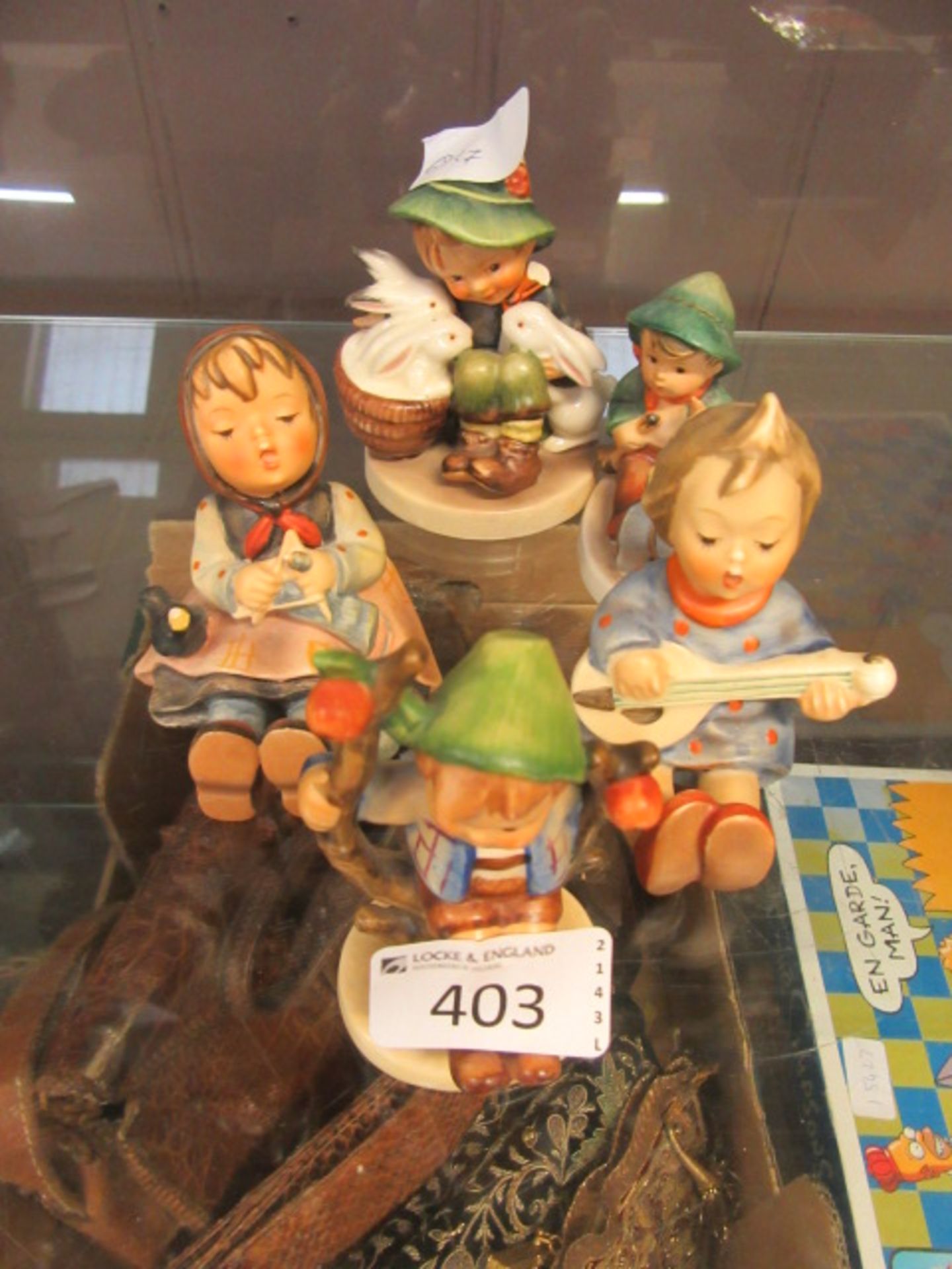 Five Goebel figurines CONDITION REPORT: Chips to shoulder of boy with rabbits,