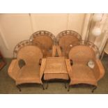 A wicker and metal conservatory suite comprising of four chairs and occasional table