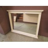 A cream framed mirror