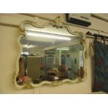 A cream and parcel gilt framed ornate mirror