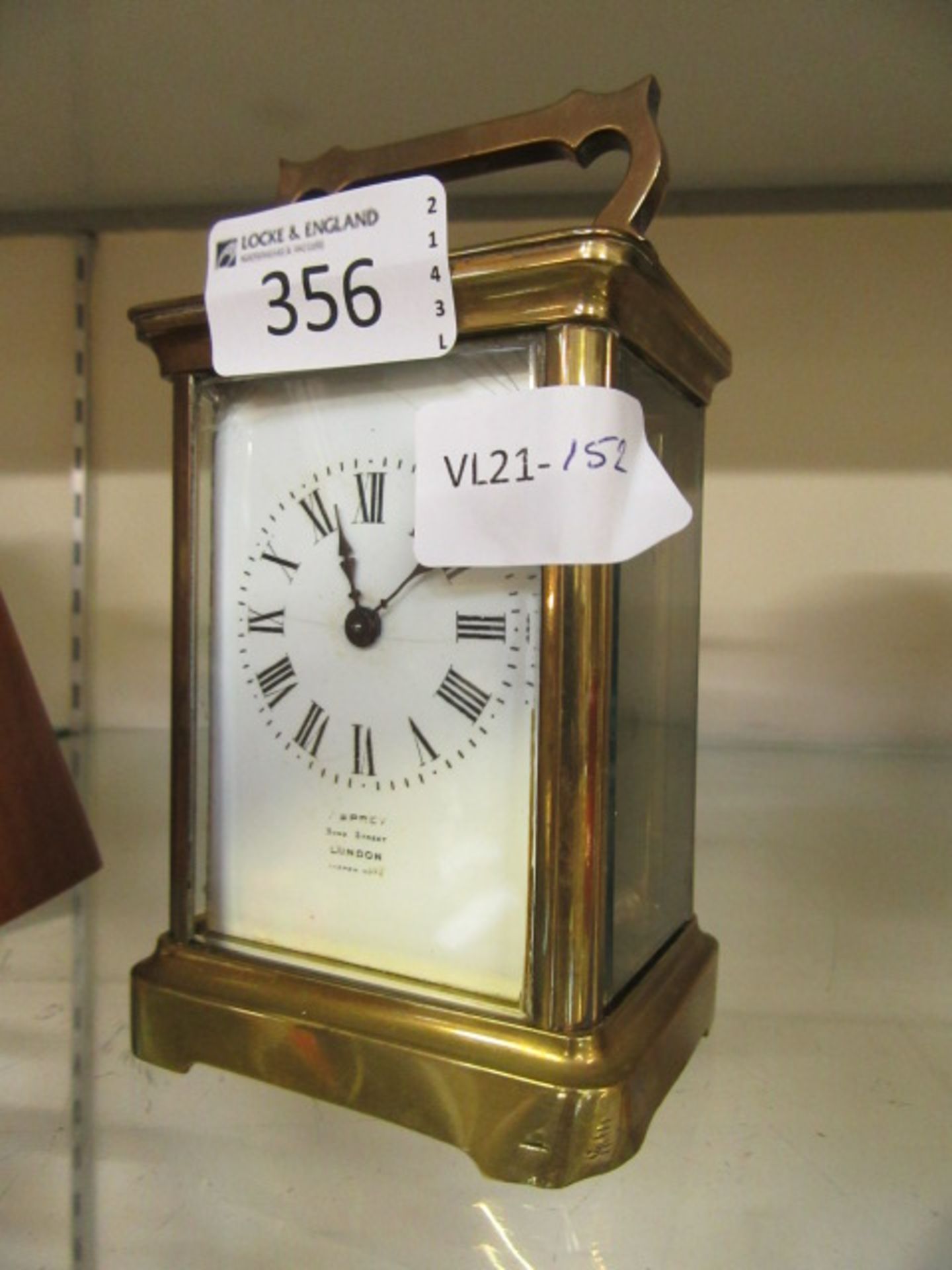 A brass and glass carriage clock CONDITION REPORT: Slght cracks to face, key present,