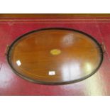 An early 20th century mahogany inlaid oval tray