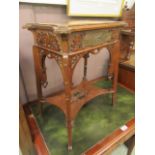 An Edwardian mahogany occasional table with carved under tier