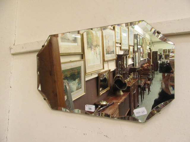 A mid-20th century bevel glass wall mirror
