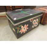 A painted metal travelling trunk