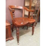 An early 20th century oak tub back study chair