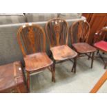 A pair plus one of wheel back chairs