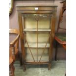 A mid-20th century oak cased and glazed display cabinet