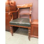 A 19th century oak open arm study chair